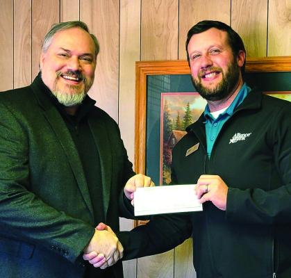 Property owner Matt Glover accepts the check from Jeff Byrnes, Treasurer of the Industrial Foundation. The property will serve as an entry to the IF’s new housing development project from Highway 37 in Mount Vernon. Courtesy photo