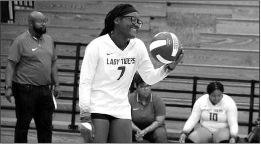 One of Clarksville volleyball Tiger jokes with her team as her coach looks on. Photo by Don Fisher