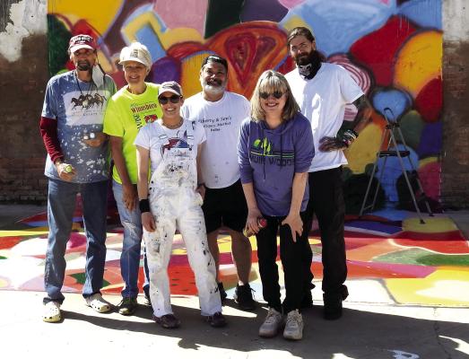 Wood County Walls artists Christopher Wayne Brown and Jaci Mouser lead volunteers Dennis Howard, Riley Alexander and other painters at the site of the new mural at 206 Market Street. Scan the KeyHole with your phone to see a time-lapse video of their work. Photo Courtesy of Jim Willis, Winnsboro Center for the Arts