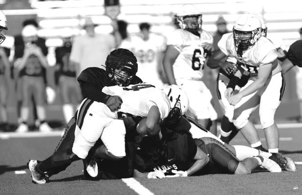 Defensive lineman Carter Cousin brings down the Bears ball carrier in Friday’s scrimmage. Photo by Shiela Haynes